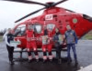 air ambulance crew standing in front of their helicopter