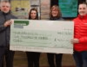 countryside services ltd staff holding a big cheque to donate to charity