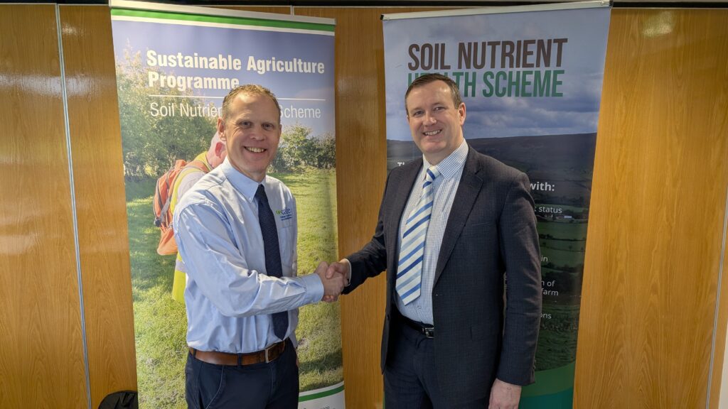 Two men shaking hands, promotional banners.