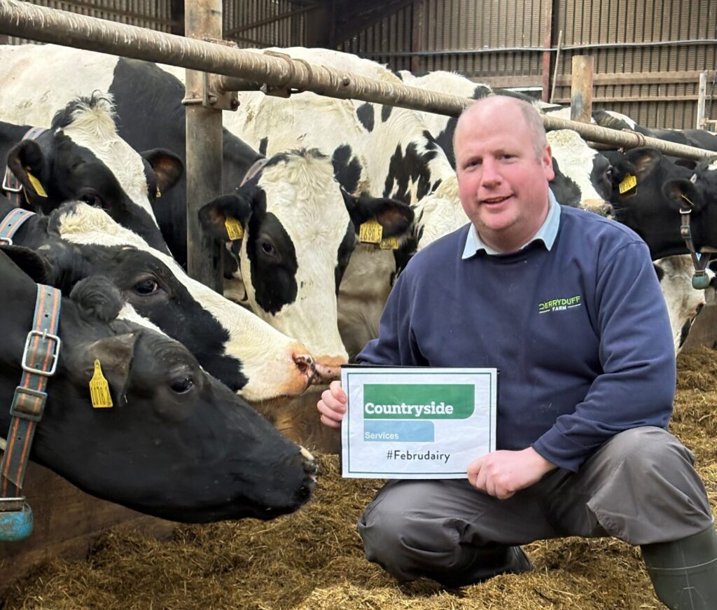 Derryduff farm; Person with cows in a barn.